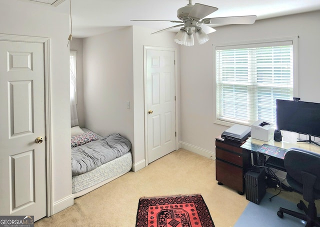 bedroom with baseboards, ceiling fan, attic access, and light colored carpet