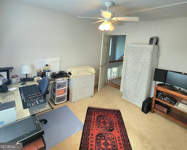 office space with ceiling fan and light carpet