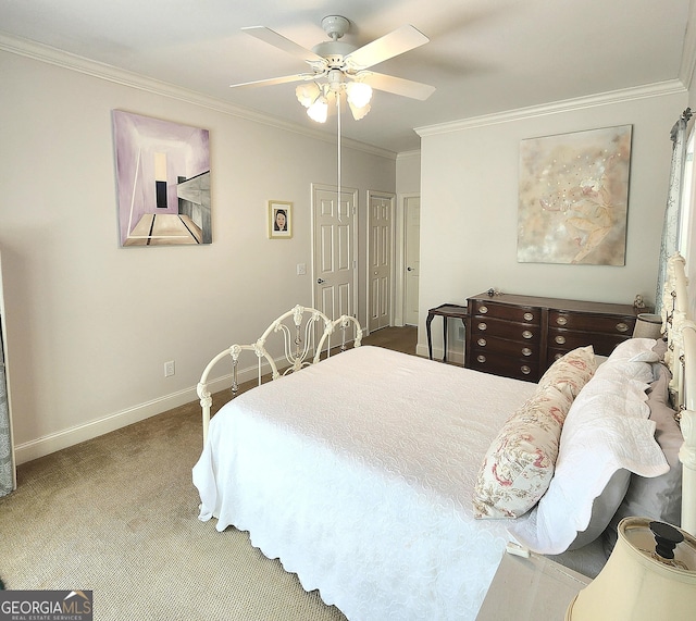 carpeted bedroom with crown molding, baseboards, and ceiling fan