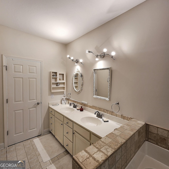 full bath featuring double vanity, a sink, a bath, and tile patterned floors