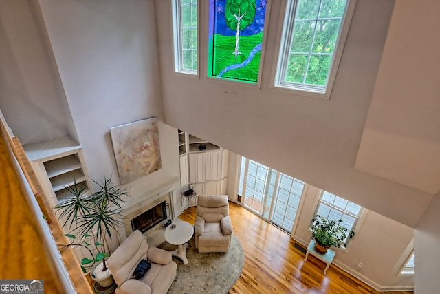 327 Kissimmee Trl, Cornelia, GA 30531 - living room featuring healthy amount of natural light, wood finished floors, and a tiled fireplace
