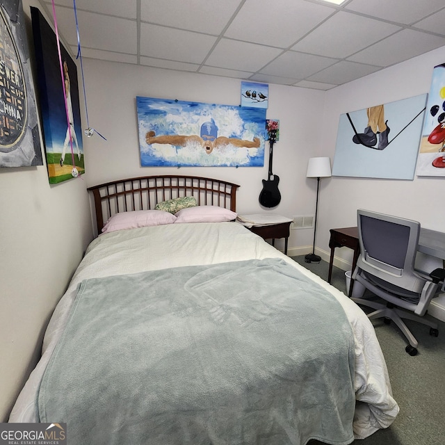 bedroom featuring carpet floors, baseboards, and a drop ceiling