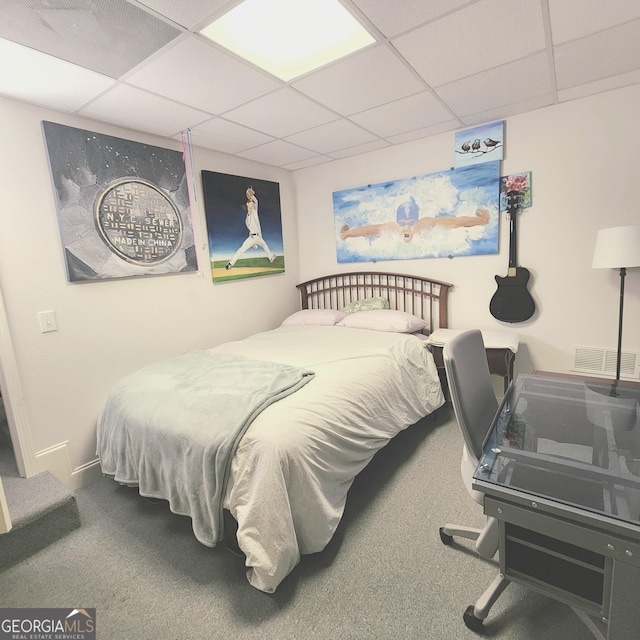 bedroom with visible vents, carpet, and a drop ceiling