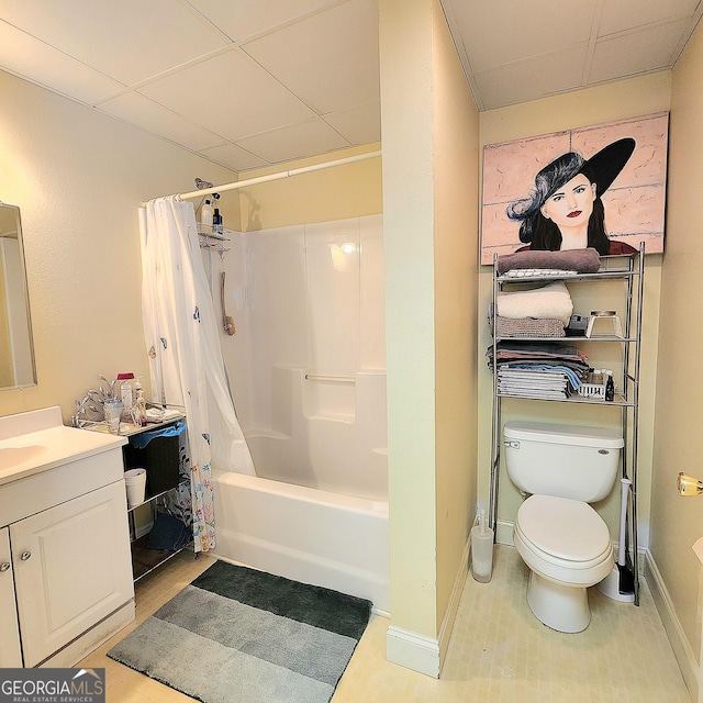 full bath featuring vanity, shower / bath combination with curtain, toilet, baseboards, and a paneled ceiling