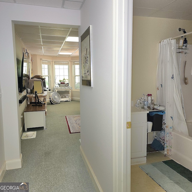 hallway featuring baseboards