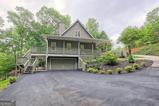 327 Kissimmee Trl, Cornelia, GA 30531 - farmhouse featuring stairs, covered porch, a chimney, and driveway