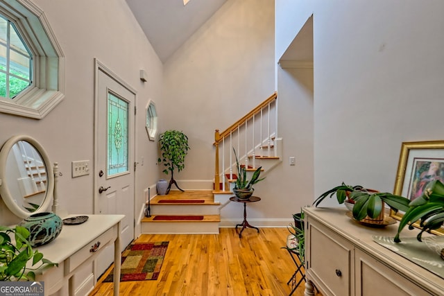 327 Kissimmee Trl, Cornelia, GA 30531 - entrance foyer with stairs, light wood-type flooring, baseboards, and high vaulted ceiling