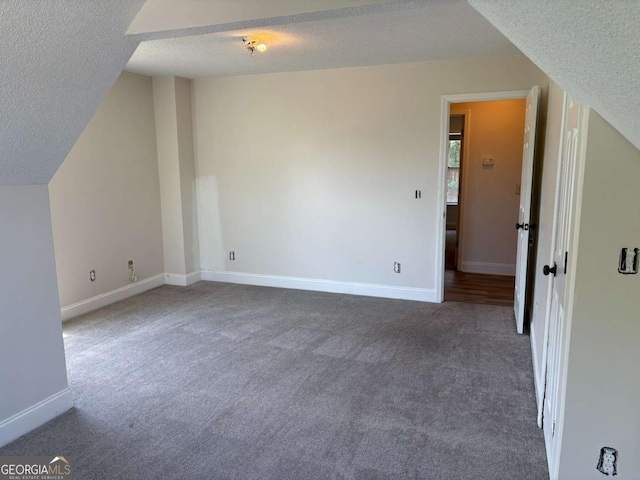 4234 Winston Cir, Atlanta, GA 30349 - additional living space featuring lofted ceiling, baseboards, carpet flooring, and a textured ceiling