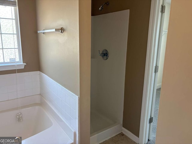4234 Winston Cir, Atlanta, GA 30349 - full bathroom with a bath and a stall shower