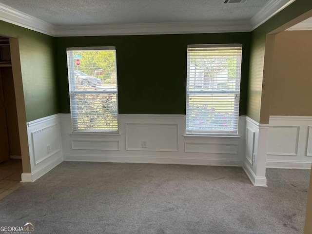 4234 Winston Cir, Atlanta, GA 30349 - unfurnished room featuring a wainscoted wall, carpet flooring, a textured ceiling, visible vents, and crown molding