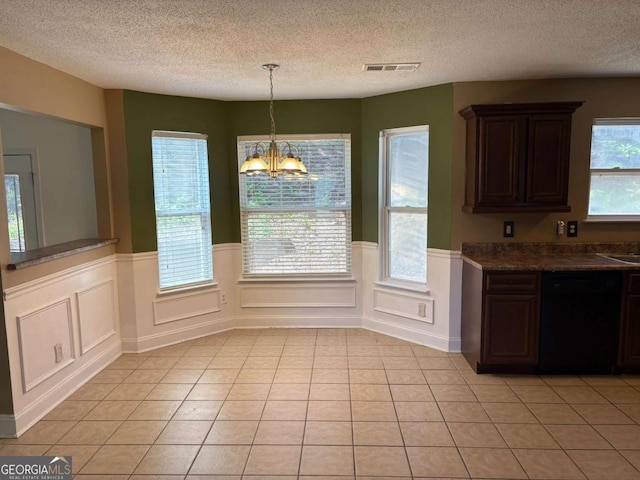 4234 Winston Cir, Atlanta, GA 30349 - unfurnished dining area featuring a wainscoted wall, visible vents, a textured ceiling, and a chandelier