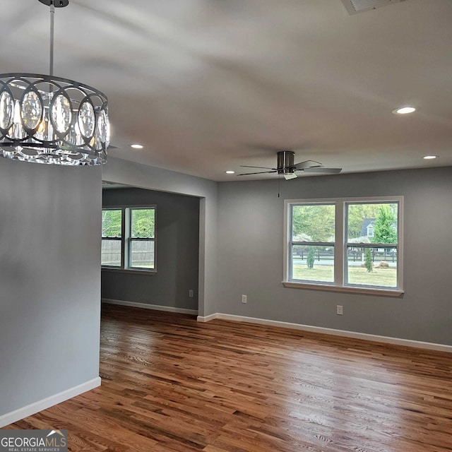 empty room with baseboards, a ceiling fan, wood finished floors, and recessed lighting
