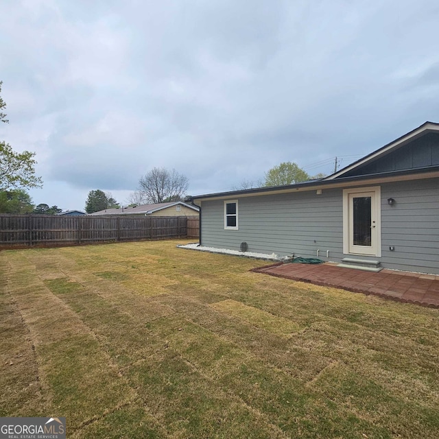 view of yard featuring fence and a patio