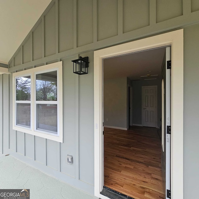 property entrance featuring board and batten siding