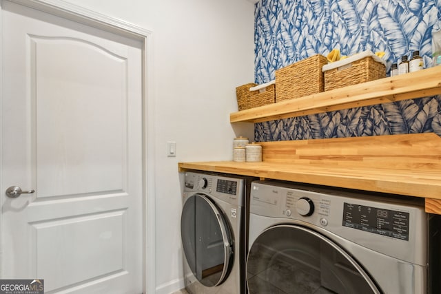 laundry area featuring tile patterned floors, washer and clothes dryer, and laundry area