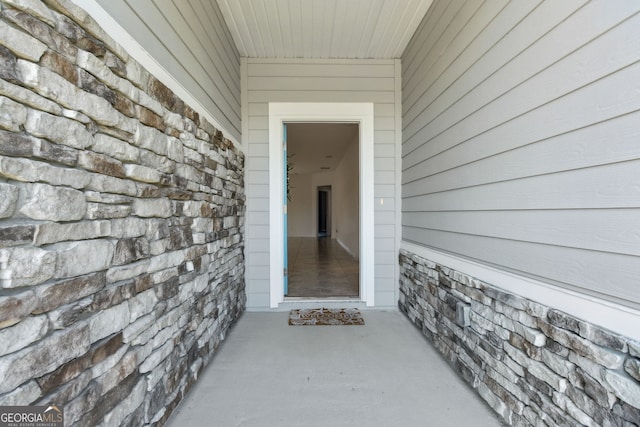 doorway to property with stone siding