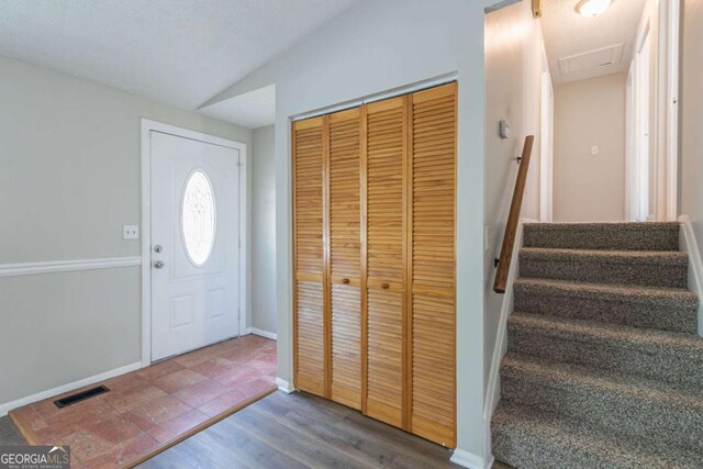 2092 Countydown Ln, Stone Mountain, GA 30088 - foyer entrance with lofted ceiling, visible vents, baseboards, and stairway