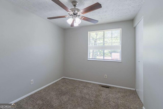 2092 Countydown Ln, Stone Mountain, GA 30088 - unfurnished room with visible vents, carpet floors, baseboards, a textured ceiling, and ceiling fan