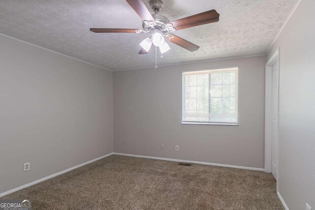 2092 Countydown Ln, Stone Mountain, GA 30088 - carpeted spare room featuring crown molding, a textured ceiling, ceiling fan, baseboards, and visible vents
