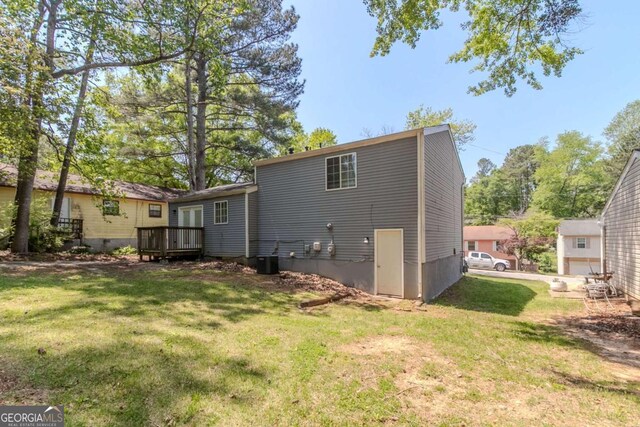 2092 Countydown Ln, Stone Mountain, GA 30088 - back of house featuring a yard, central air condition unit, and a deck
