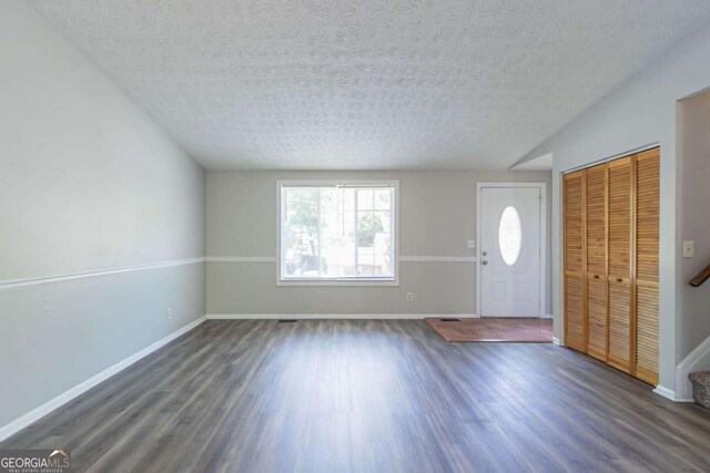 2092 Countydown Ln, Stone Mountain, GA 30088 - foyer with a textured ceiling, baseboards, and dark wood-style flooring