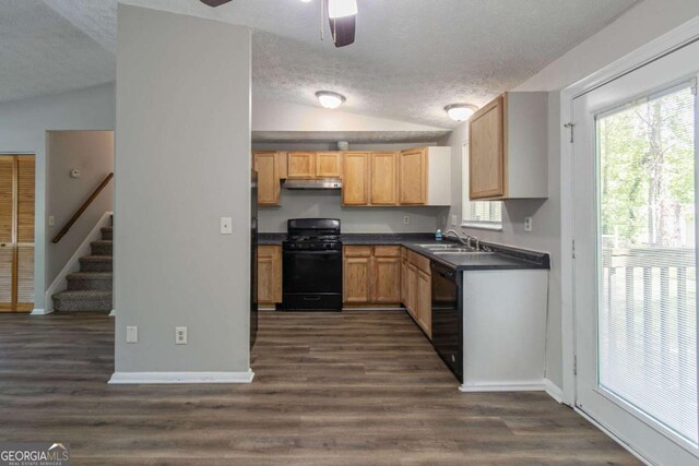 2092 Countydown Ln, Stone Mountain, GA 30088 - kitchen featuring a sink, a textured ceiling, dark countertops, vaulted ceiling, and black appliances