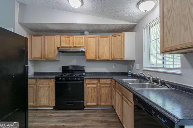 2092 Countydown Ln, Stone Mountain, GA 30088 - kitchen featuring under cabinet range hood, vaulted ceiling, a sink, black appliances, and a textured ceiling