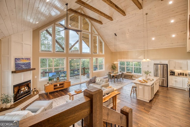 1016 Twisted Oak Rd Unit 115, Talking Rock, GA 30175 - living room featuring high vaulted ceiling, plenty of natural light, a warm lit fireplace, a wood ceiling with exposed beams, and dark wood-type flooring
