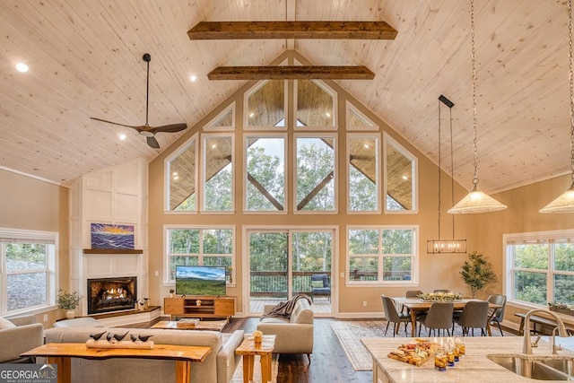 1016 Twisted Oak Rd Unit 115, Talking Rock, GA 30175 - living area with high vaulted ceiling, a wooden ceiling with exposed beams, wood finished floors, healthy amount of natural light, and a lit fireplace
