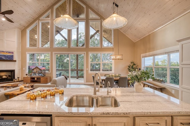 1016 Twisted Oak Rd Unit 115, Talking Rock, GA 30175 - kitchen featuring high vaulted ceiling, wood ceiling, open floor plan, a fireplace with raised hearth, and light stone counters