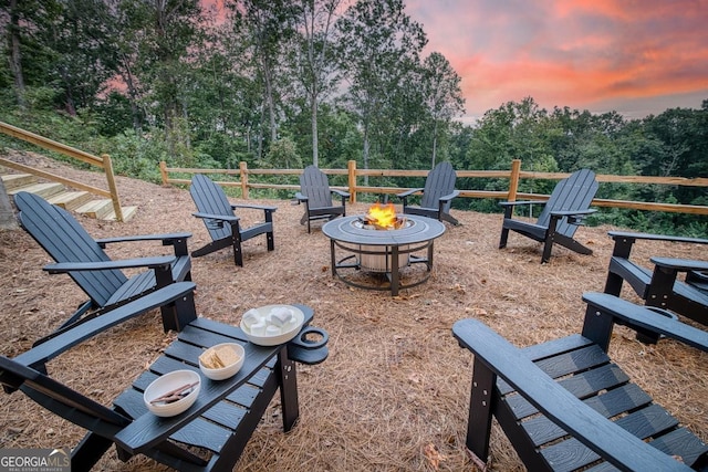1016 Twisted Oak Rd Unit 115, Talking Rock, GA 30175 - patio terrace at dusk featuring a fire pit and view of wooded area