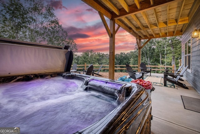 1016 Twisted Oak Rd Unit 115, Talking Rock, GA 30175 - patio terrace at dusk featuring a hot tub and view of scattered trees