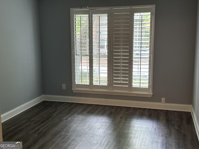 4828 Westridge Dr, Norcross, GA 30093 - spare room featuring dark wood-style flooring, a healthy amount of sunlight, and baseboards