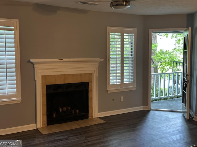4828 Westridge Dr, Norcross, GA 30093 - unfurnished living room featuring baseboards, visible vents, wood finished floors, and a tile fireplace