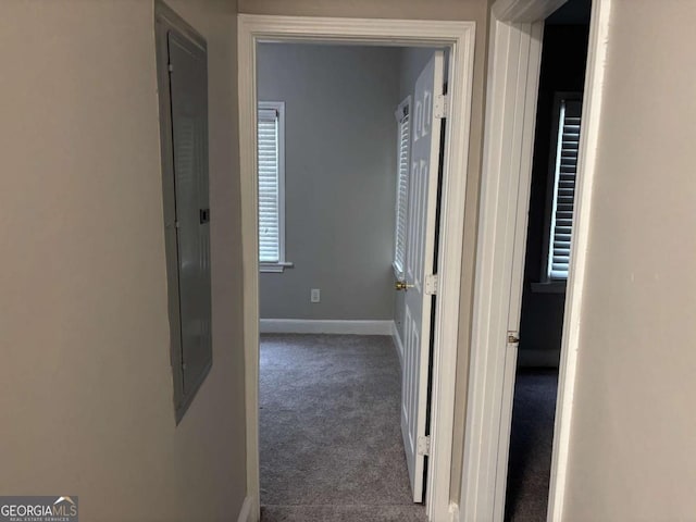 hall featuring carpet floors and baseboards