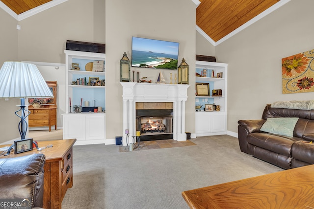 carpeted living room featuring a tiled fireplace, baseboards, wood ceiling, high vaulted ceiling, and ornamental molding