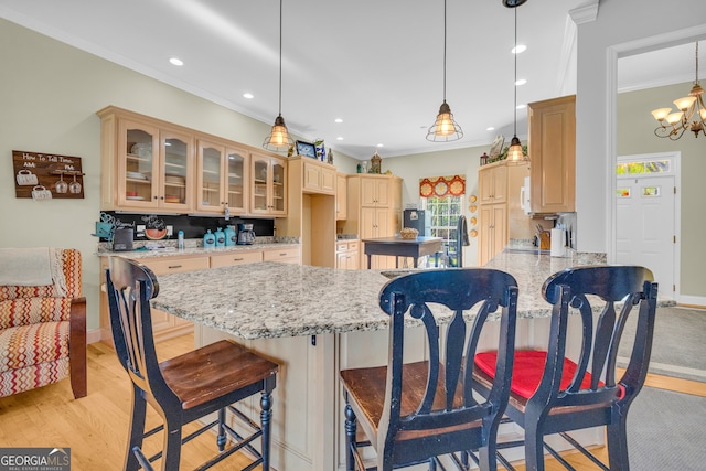 kitchen featuring recessed lighting, a peninsula, crown molding, and glass insert cabinets