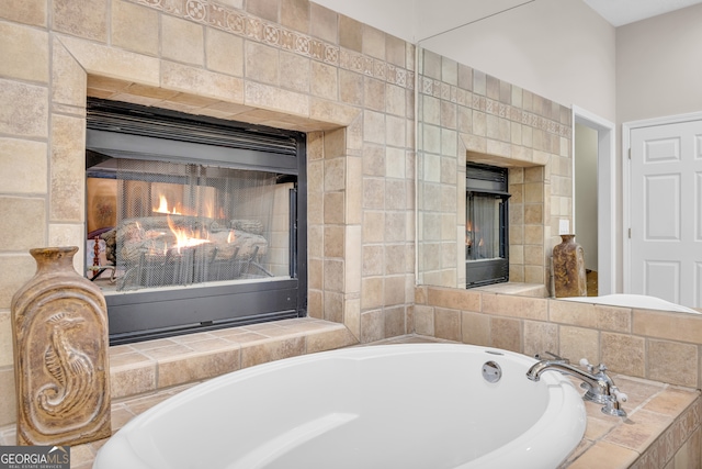 bathroom with a bath and a tile fireplace