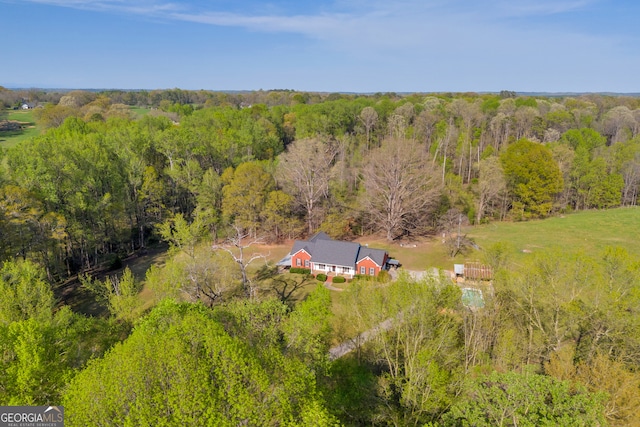 drone / aerial view featuring a wooded view