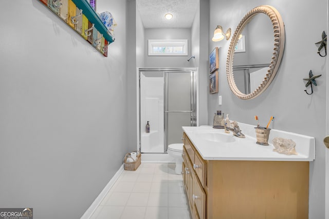 full bathroom with toilet, vanity, a textured ceiling, and a stall shower