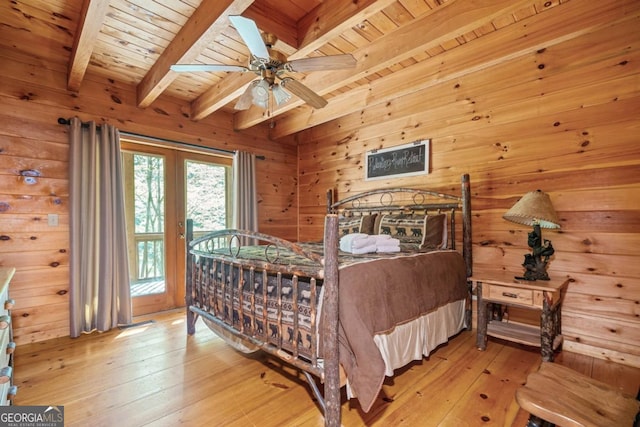 bedroom featuring light wood-type flooring, wood ceiling, wood walls, beam ceiling, and access to exterior