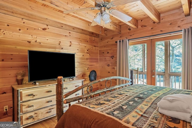 bedroom with wood walls, wood finished floors, wooden ceiling, french doors, and beamed ceiling