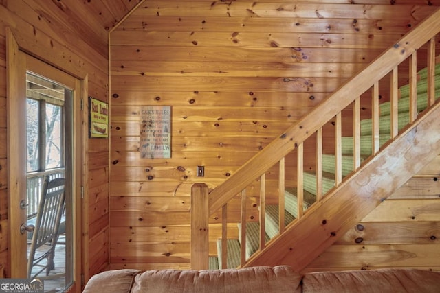 staircase with wooden walls and wooden ceiling