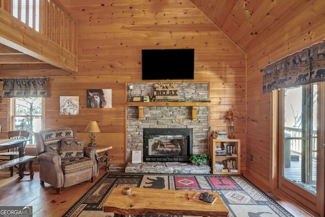 living area with wooden walls and hardwood / wood-style floors