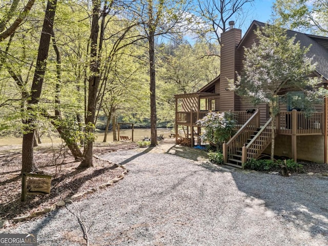 view of yard featuring a wooden deck and stairs