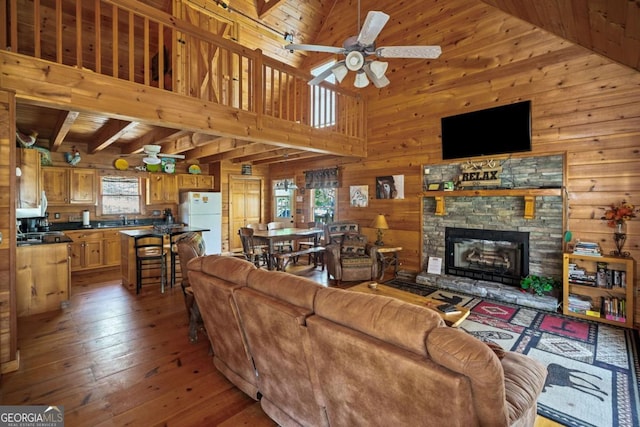 living room featuring wood walls and high vaulted ceiling