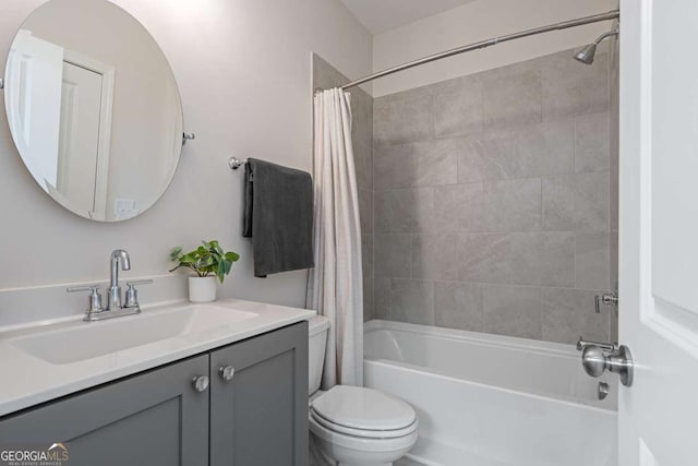 bathroom featuring shower / bath combination with curtain, vanity, and toilet