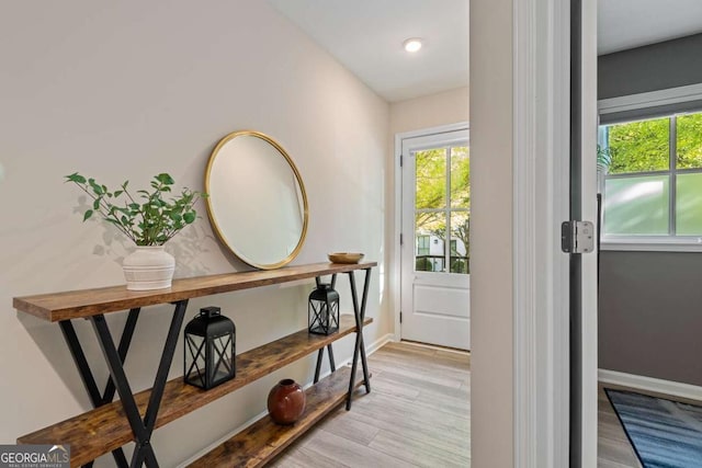 doorway to outside with light wood finished floors, baseboards, and recessed lighting