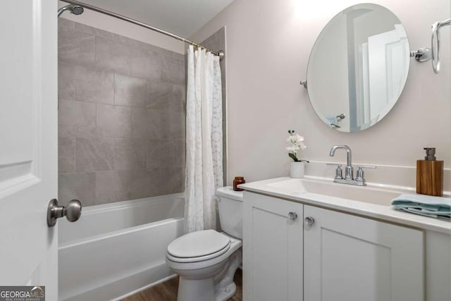 full bathroom with wood finished floors, shower / bath combination with curtain, vanity, and toilet