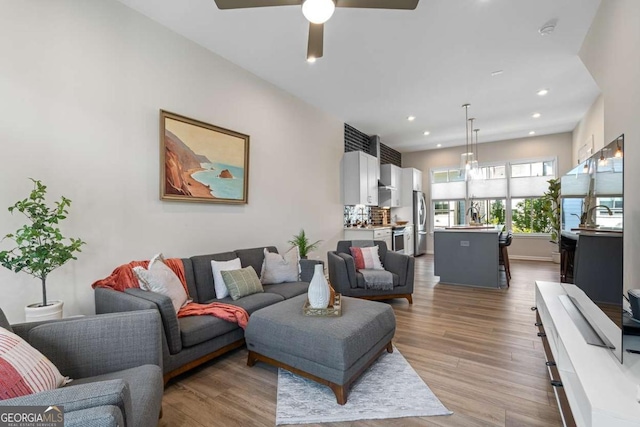 living room featuring a ceiling fan, wood finished floors, and recessed lighting